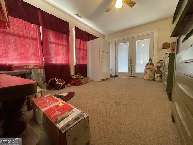 miscellaneous room with ceiling fan, french doors, and carpet