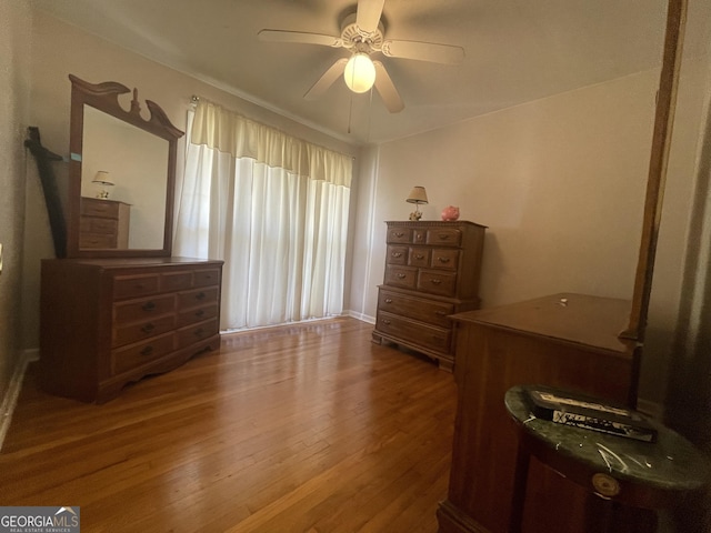 bedroom with hardwood / wood-style floors and ceiling fan