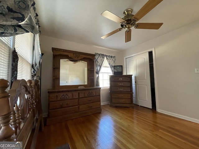 bedroom featuring hardwood / wood-style flooring, ceiling fan, and a closet