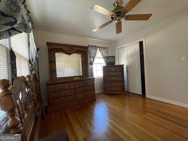 unfurnished bedroom featuring ceiling fan, a closet, and hardwood / wood-style flooring