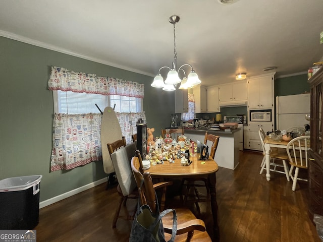 dining room with dark hardwood / wood-style flooring, an inviting chandelier, and ornamental molding