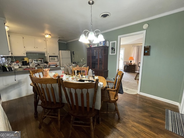 dining space with a chandelier, dark hardwood / wood-style floors, and ornamental molding