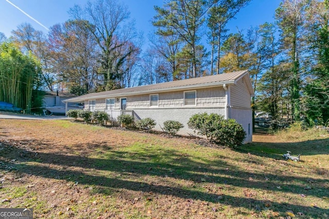 8775 Lee Rd, Lithia Springs, GA 30122 - view of front of property with a front lawn, a metal roof, a standing seam roof, and brick siding