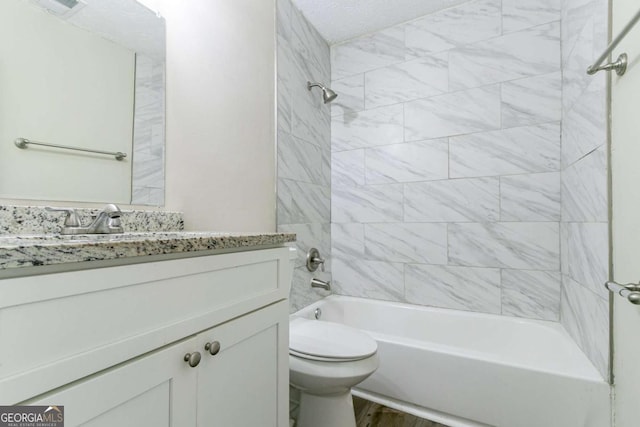 full bathroom featuring vanity, toilet, wood-type flooring, and tiled shower / bath