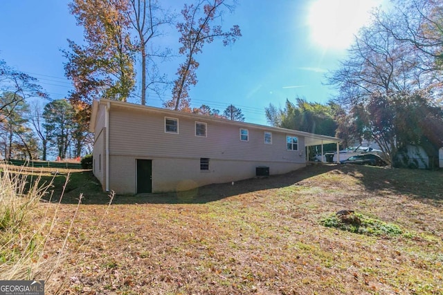 back of house with a yard and central AC unit