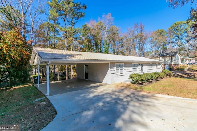 8775 Lee Rd, Lithia Springs, GA 30122 - view of front of property featuring driveway, a carport, a metal roof, and brick siding