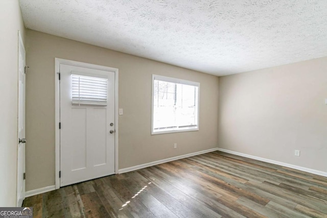 8775 Lee Rd, Lithia Springs, GA 30122 - foyer featuring wood finished floors and a textured ceiling