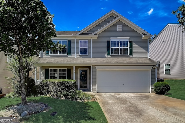 view of front of property featuring a garage and a front lawn