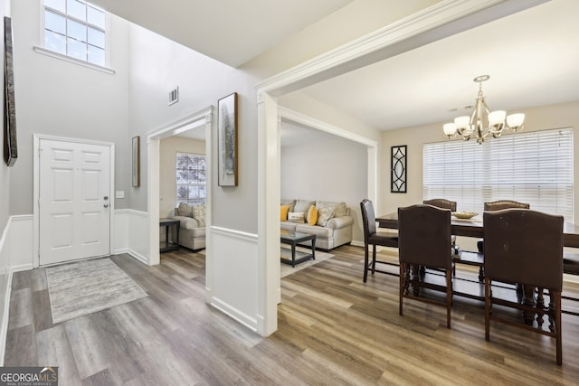 entrance foyer with a notable chandelier and wood-type flooring