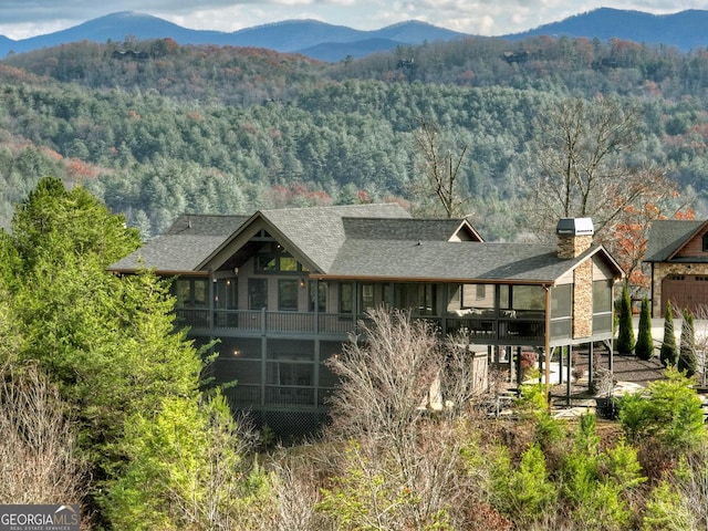 exterior space with a mountain view and a sunroom