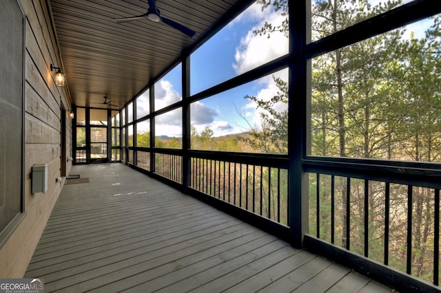 unfurnished sunroom featuring ceiling fan and wood ceiling