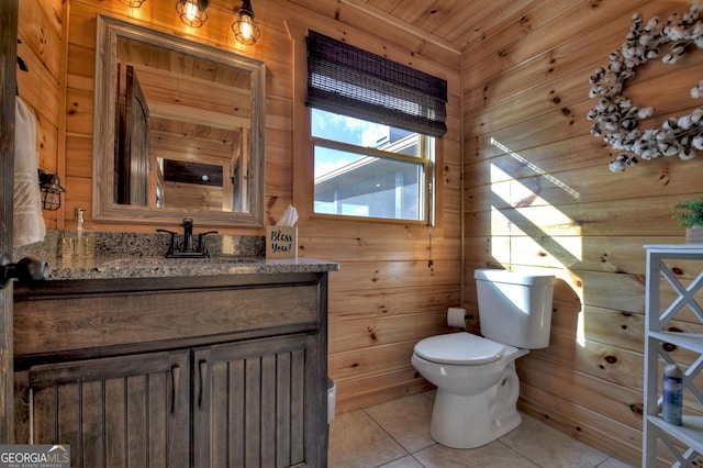 bathroom featuring tile patterned flooring, vanity, wood walls, and wooden ceiling