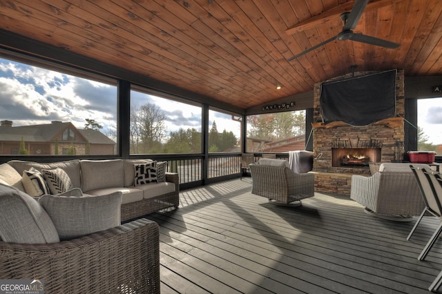 wooden deck featuring an outdoor living space with a fireplace and ceiling fan