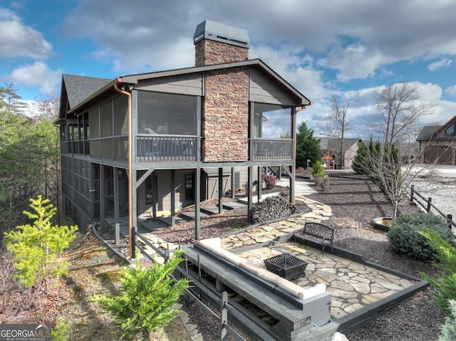 back of house with a sunroom and a patio area