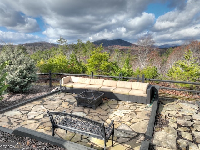 view of patio featuring a fire pit and a mountain view