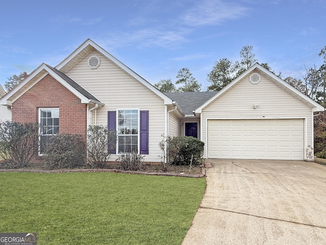 view of front of home with a front lawn and a garage