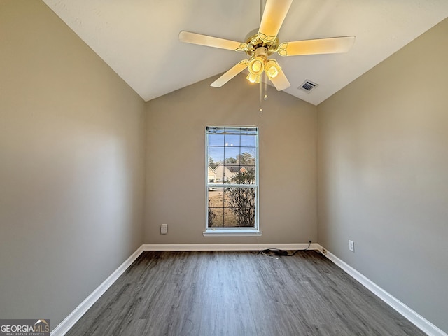 empty room featuring ceiling fan, dark hardwood / wood-style flooring, and lofted ceiling