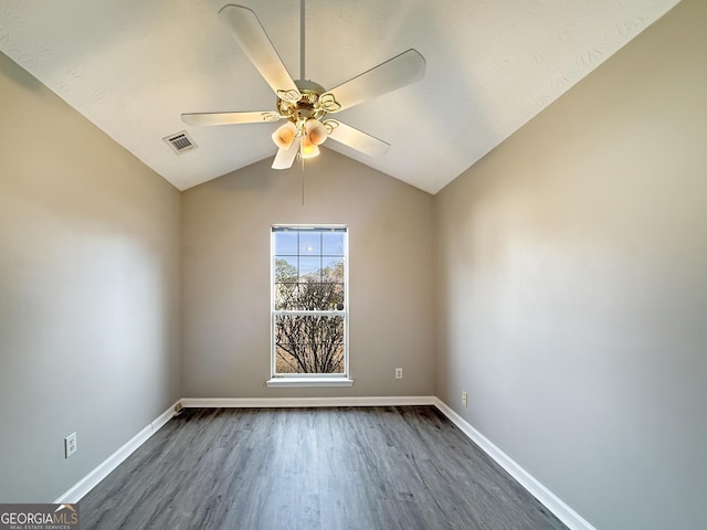 spare room featuring ceiling fan, lofted ceiling, and dark wood-type flooring