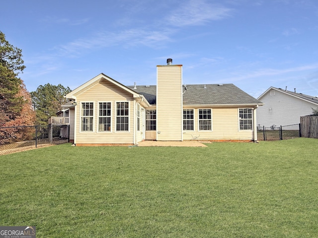 rear view of property with a lawn