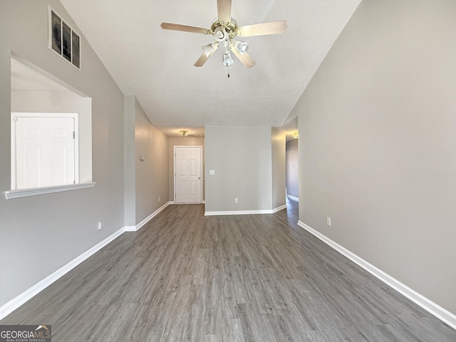 empty room featuring dark hardwood / wood-style flooring and ceiling fan