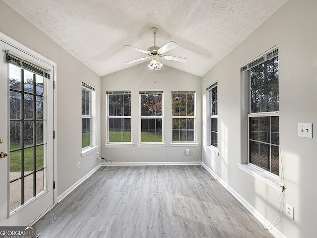 unfurnished sunroom with a wealth of natural light, ceiling fan, and lofted ceiling