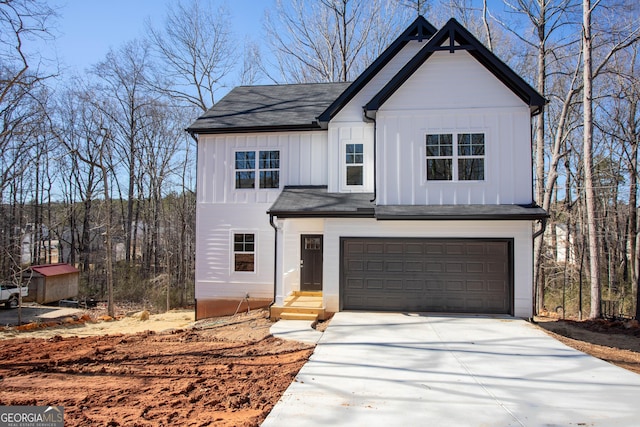 view of front of home featuring entry steps, concrete driveway, board and batten siding, and an attached garage