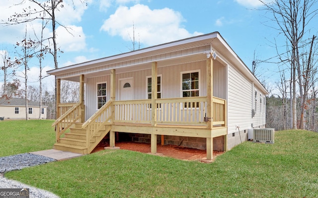 view of front facade with a porch, a front lawn, and central air condition unit