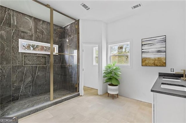 bathroom with vanity and a shower with shower door