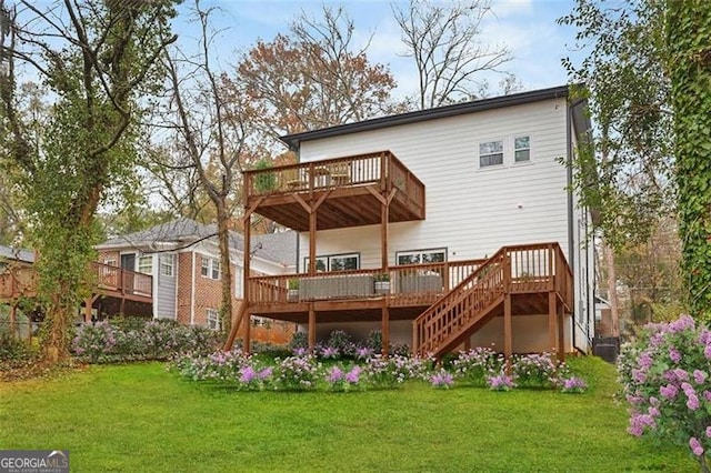 rear view of property featuring a yard and a deck