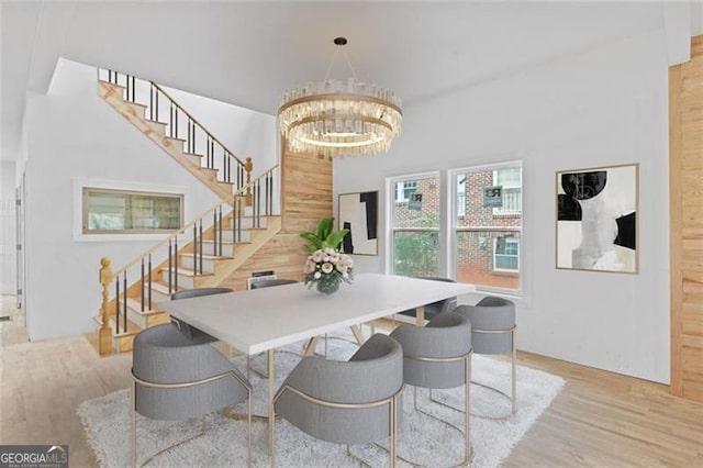 dining area featuring light hardwood / wood-style flooring and a notable chandelier