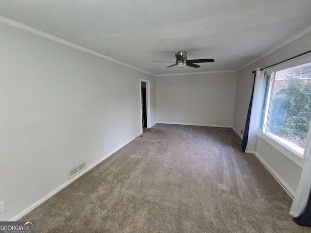 carpeted empty room featuring ceiling fan and crown molding