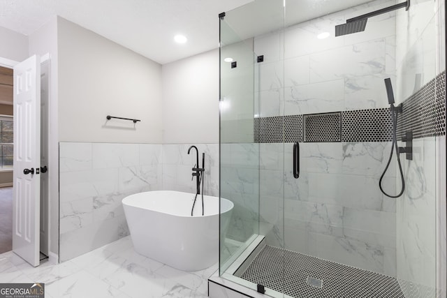 bathroom featuring separate shower and tub and tile walls