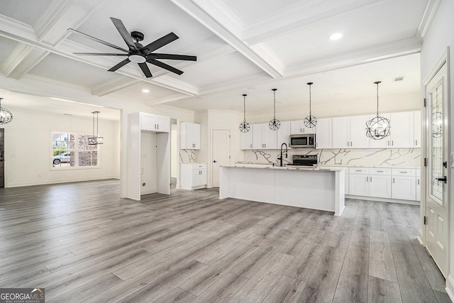 kitchen with white cabinets, appliances with stainless steel finishes, and light hardwood / wood-style floors