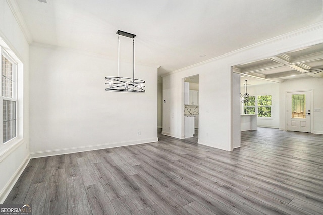 unfurnished dining area featuring hardwood / wood-style floors, crown molding, beamed ceiling, and coffered ceiling