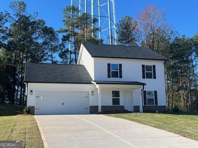 view of front of house with a front yard and a garage