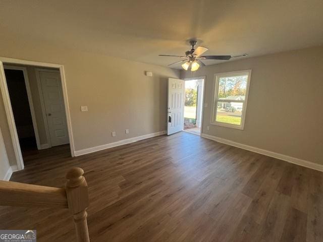 spare room featuring dark hardwood / wood-style floors and ceiling fan