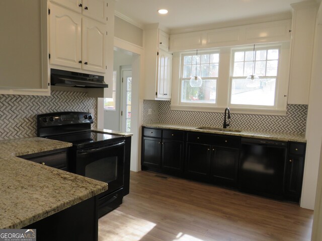 kitchen with tasteful backsplash, sink, black appliances, light hardwood / wood-style floors, and white cabinetry