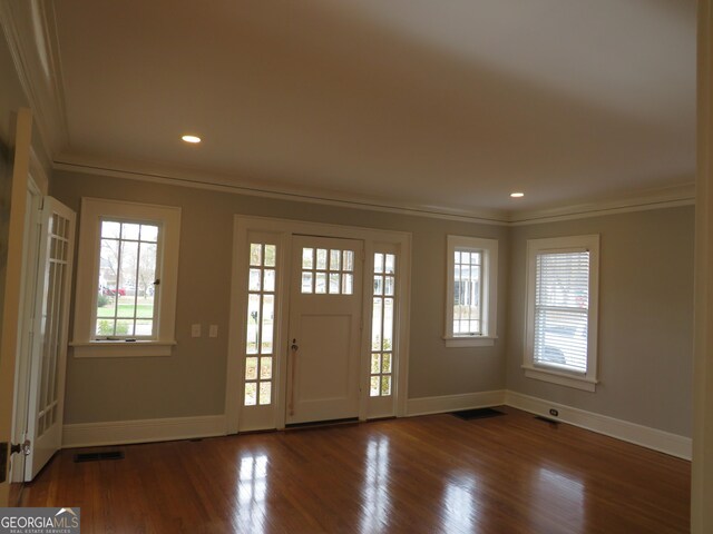 entrance foyer featuring hardwood / wood-style floors and crown molding