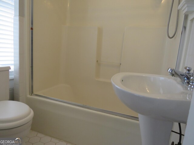 full bathroom with tile patterned flooring, toilet, combined bath / shower with glass door, and sink