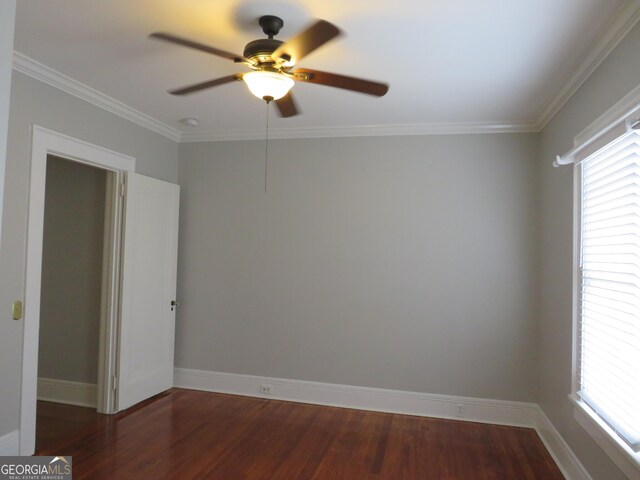 unfurnished room with ceiling fan, dark hardwood / wood-style floors, and ornamental molding