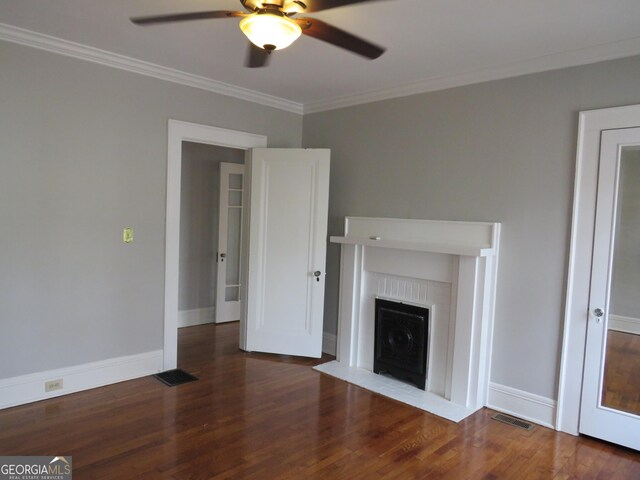 unfurnished living room featuring dark hardwood / wood-style floors, ceiling fan, and ornamental molding