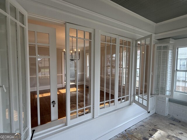 unfurnished sunroom with a notable chandelier