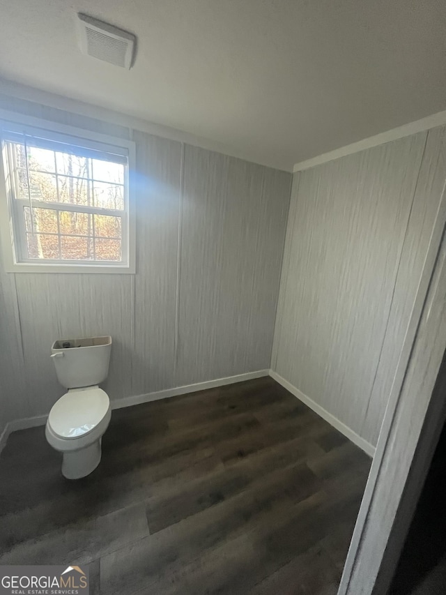 bathroom featuring toilet and wood-type flooring