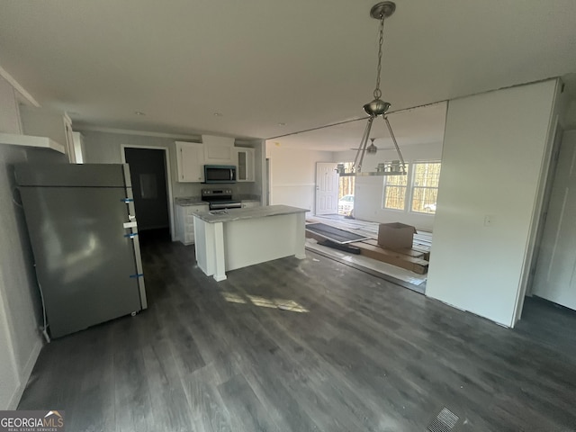 kitchen with hanging light fixtures, stainless steel appliances, a kitchen island, dark hardwood / wood-style flooring, and white cabinets