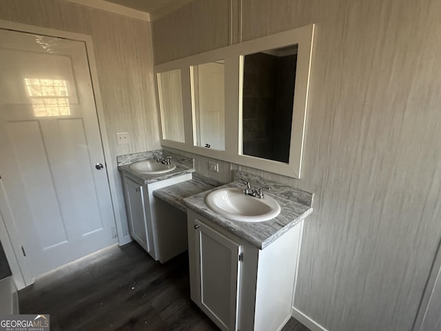 laundry area featuring sink and dark hardwood / wood-style floors