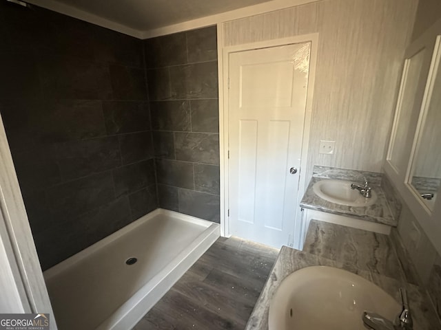 bathroom featuring plus walk in shower, hardwood / wood-style floors, and vanity