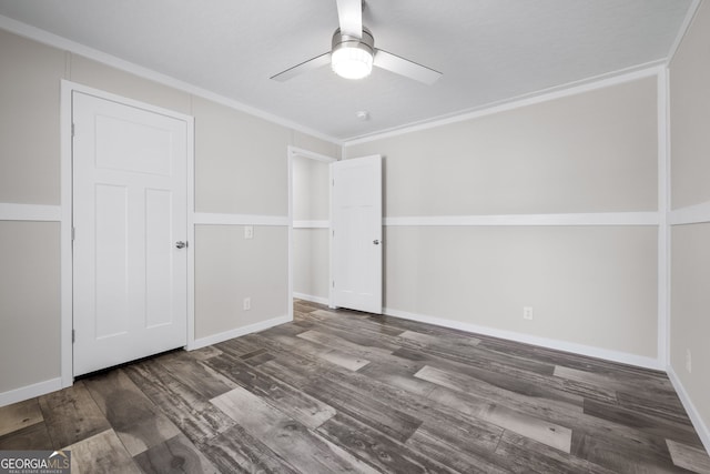 spare room featuring crown molding, ceiling fan, and dark hardwood / wood-style floors