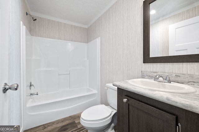 full bathroom with vanity, bathing tub / shower combination, crown molding, toilet, and wood-type flooring