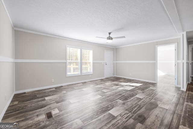 unfurnished room featuring a textured ceiling, crown molding, ceiling fan, and dark wood-type flooring