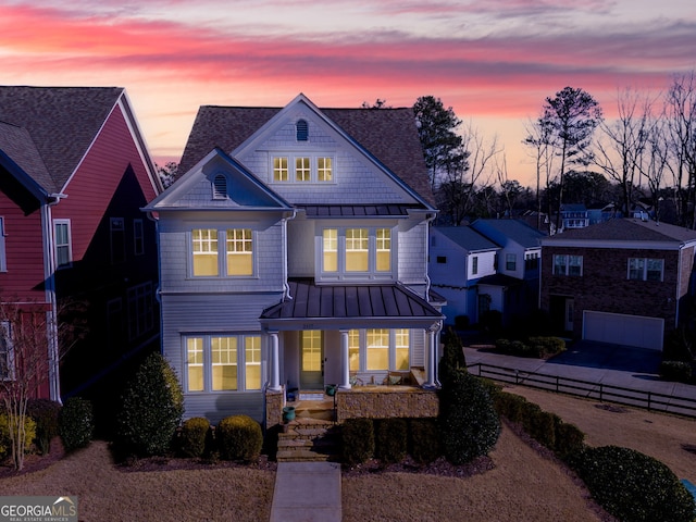 view of front of property with a porch and a garage